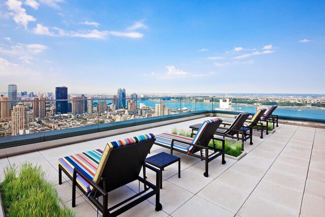 view of patio / terrace with a view of city and a water view