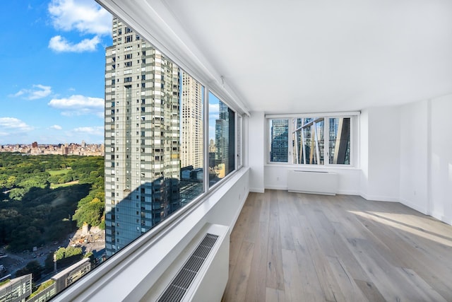balcony featuring radiator heating unit and a view of city