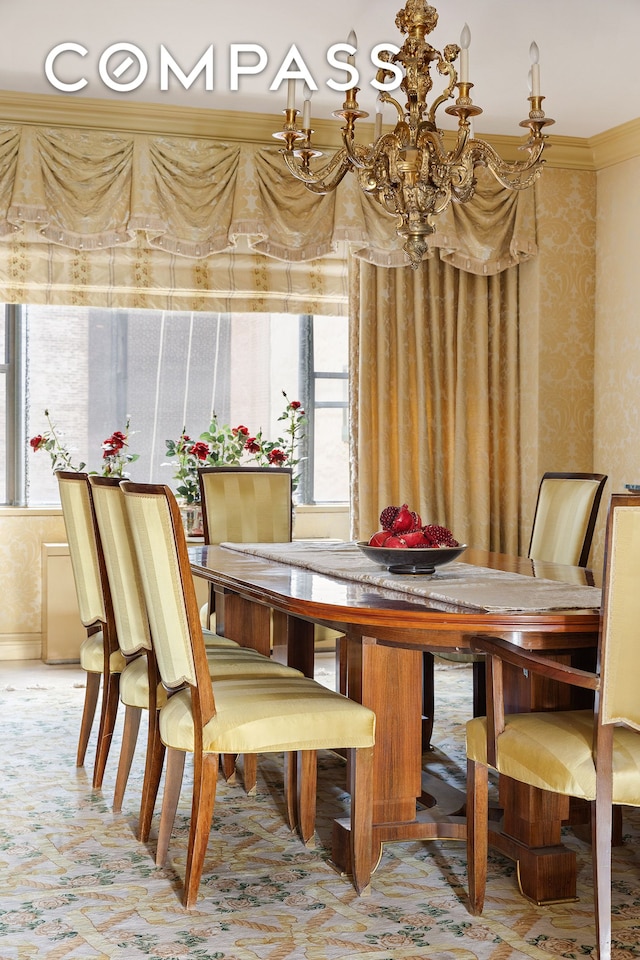 dining area with a chandelier, wallpapered walls, and crown molding