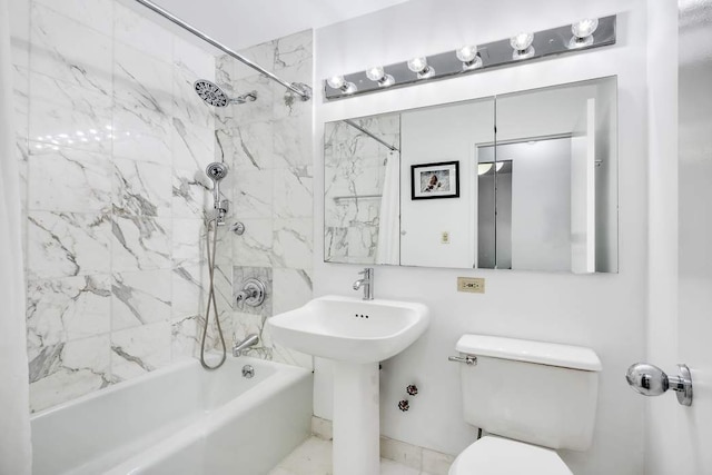 full bathroom featuring tiled shower / bath, sink, and toilet