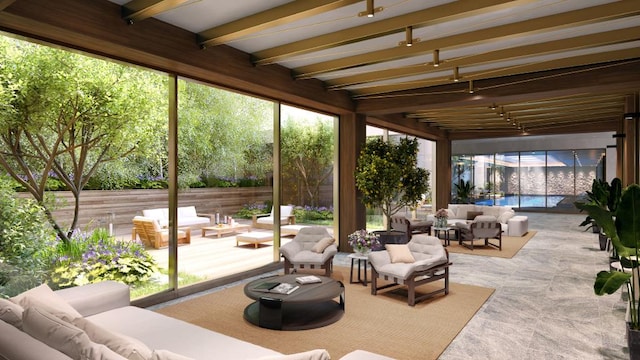 sunroom / solarium featuring beamed ceiling and a healthy amount of sunlight