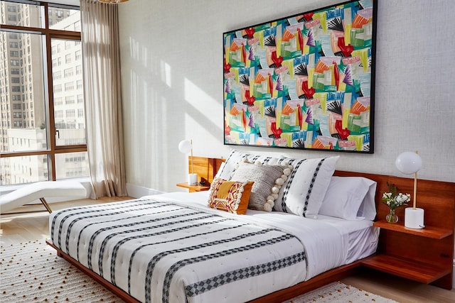 bedroom featuring multiple windows and wood finished floors