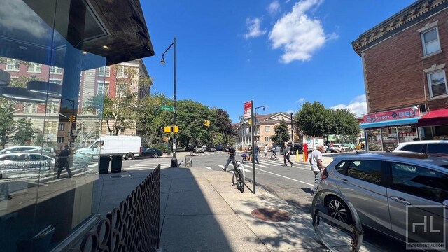 view of street featuring traffic signs, street lighting, and sidewalks