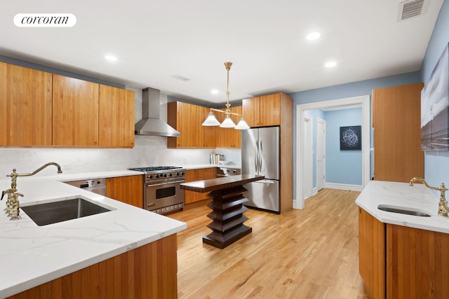 7 E 63rd St, New York City, NY 10065 - kitchen with appliances with stainless steel finishes, a sink, wall chimney range hood, and light stone countertops