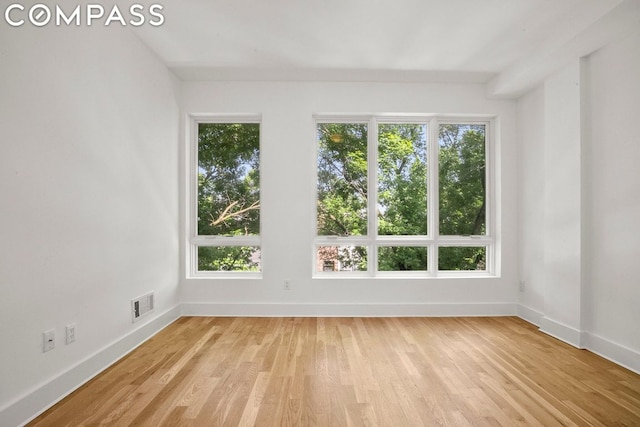 unfurnished room featuring light hardwood / wood-style floors