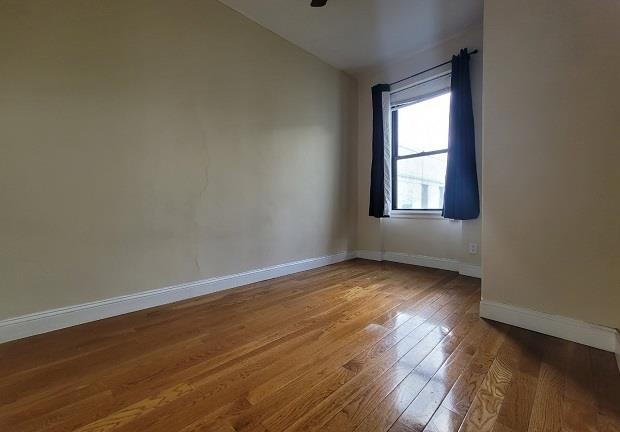 unfurnished room with wood-type flooring and lofted ceiling