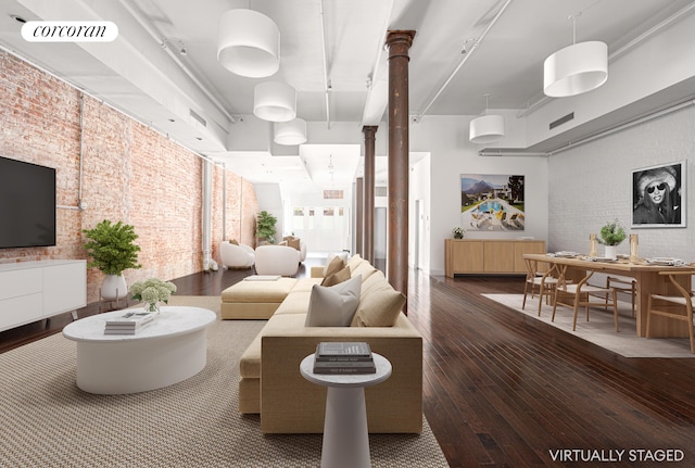 living area featuring visible vents, brick wall, and hardwood / wood-style floors