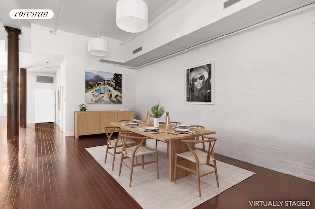 dining area featuring decorative columns, dark wood-style floors, and visible vents