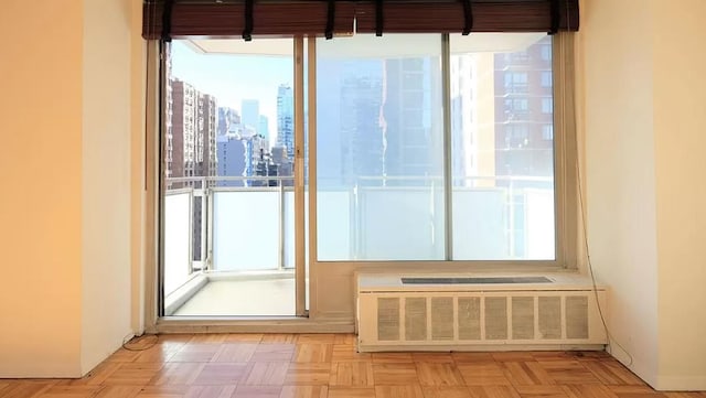 doorway featuring light parquet floors and radiator