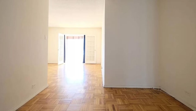 hallway featuring light parquet flooring