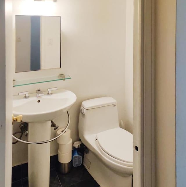 bathroom with toilet and tile patterned floors