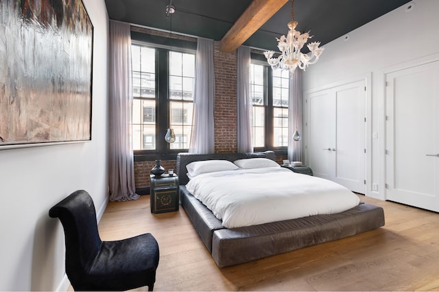 31 Washington St Unit 11, New York City, NY 11201 - bedroom featuring a chandelier, light wood-style flooring, and beam ceiling
