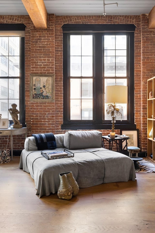 31 Washington St Unit 11, New York City, NY 11201 - living area featuring healthy amount of natural light, brick wall, and wood finished floors