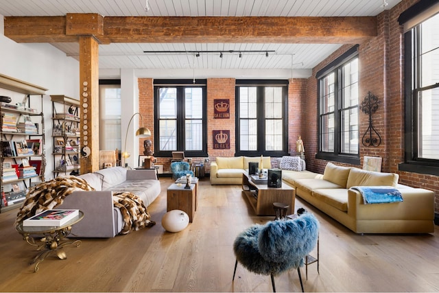 31 Washington St Unit 11, New York City, NY 11201 - living room featuring brick wall, wood finished floors, and a wooden ceiling with exposed beams