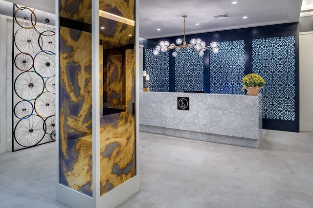 reception area with visible vents and an inviting chandelier