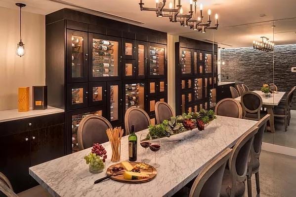 wine room with finished concrete floors and a chandelier