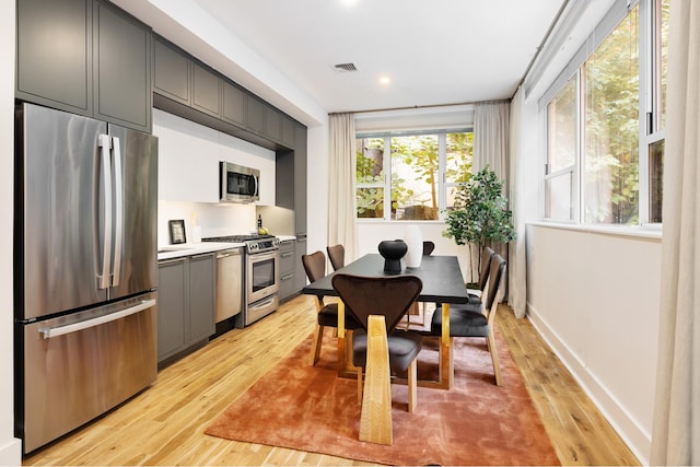 dining area with light wood-type flooring, visible vents, baseboards, and recessed lighting