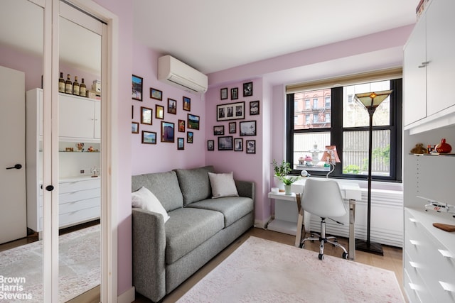 office space featuring a wall mounted air conditioner and light hardwood / wood-style floors