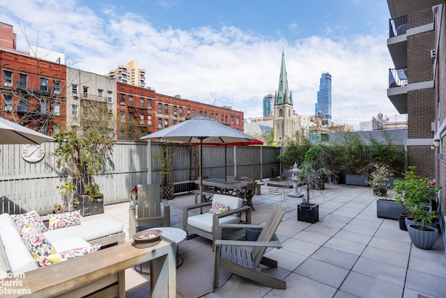 175 W 95th St Unit 2C, New York City, NY 10025 - fenced backyard featuring an outdoor hangout area, a view of city, a patio, and outdoor dining space