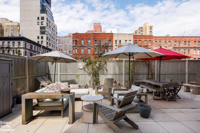 175 W 95th St Unit 2C, New York City, NY 10025 - fenced backyard featuring outdoor dining space, a patio, and a view of city