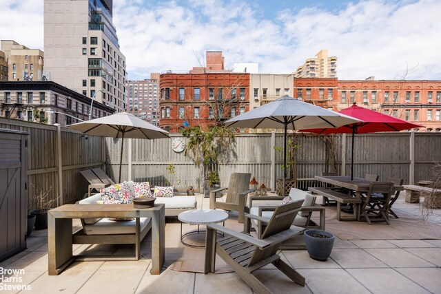 175 W 95th St Unit 2C, New York City, NY 10025 - fenced backyard with outdoor dining area, a patio area, and a view of city