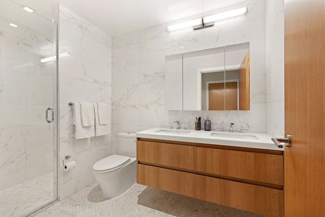 bathroom featuring tile walls, toilet, a shower stall, and a sink