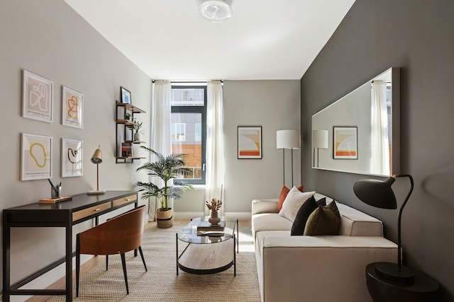 carpeted living room with baseboards