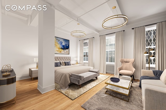 118 E 25th St Unit 8, New York City, NY 10010 - bedroom with wood-type flooring, radiator heating unit, baseboards, and beamed ceiling
