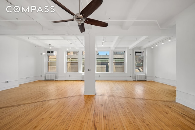 118 E 25th St Unit 8, New York City, NY 10010 - unfurnished living room featuring radiator heating unit, healthy amount of natural light, and light wood-style flooring