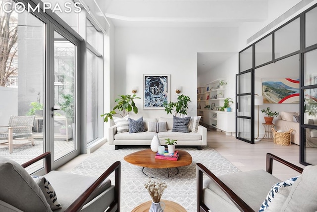 living room with plenty of natural light and light hardwood / wood-style floors