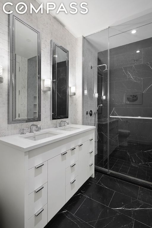 bathroom with vanity and a shower with shower door