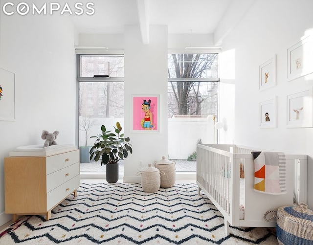 interior space featuring beamed ceiling and plenty of natural light