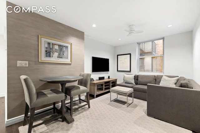 living room featuring ceiling fan, baseboards, and recessed lighting