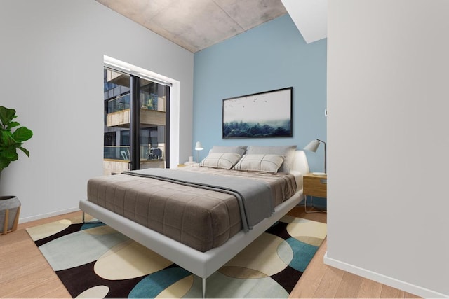 bedroom featuring light wood-type flooring and access to exterior