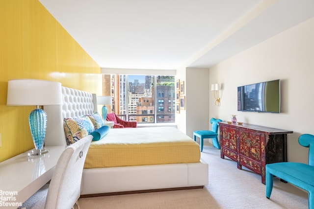 bedroom featuring expansive windows and carpet