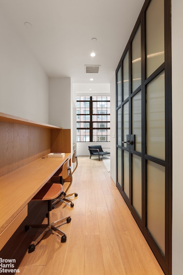 office featuring recessed lighting, light wood-type flooring, and visible vents