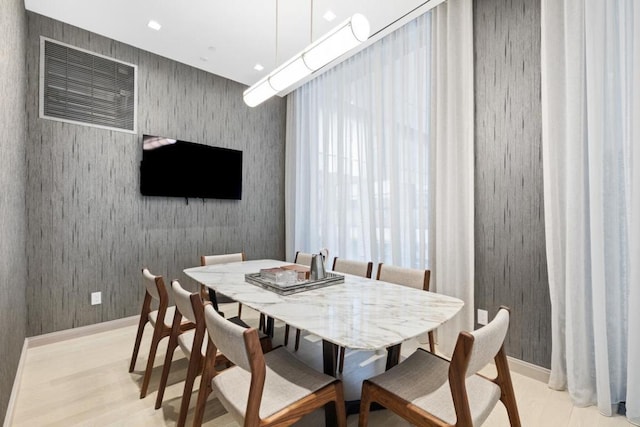 dining area with recessed lighting, light wood-style flooring, and wallpapered walls