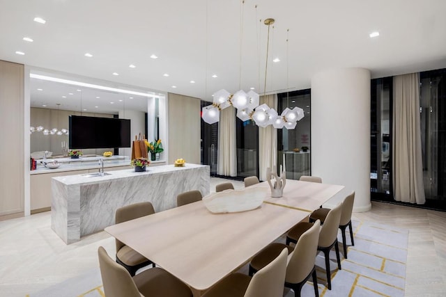 dining space featuring light parquet flooring and sink