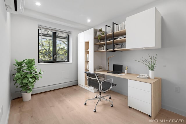 home office featuring light wood-style flooring, built in study area, a baseboard radiator, a wall unit AC, and recessed lighting