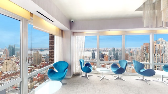 sunroom featuring a view of city and plenty of natural light