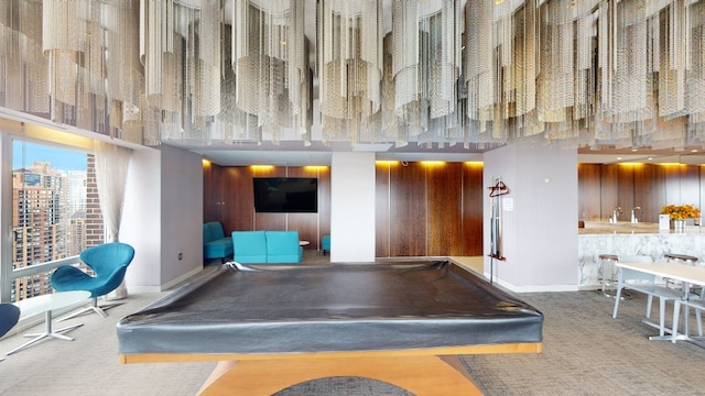 playroom featuring pool table, a towering ceiling, baseboards, a view of city, and carpet