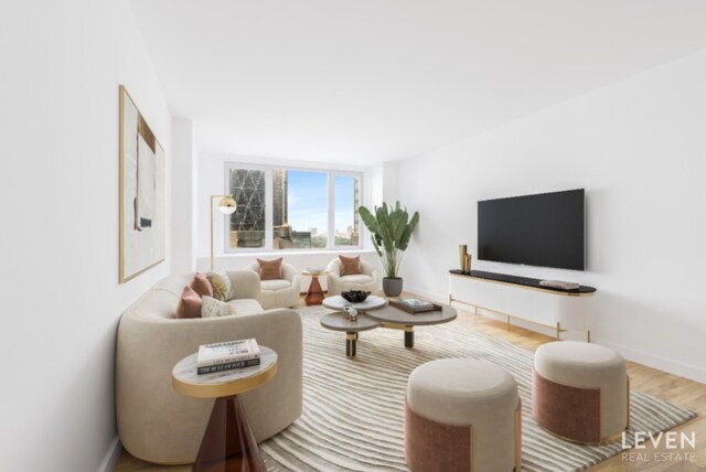 living room featuring wood finished floors and baseboards