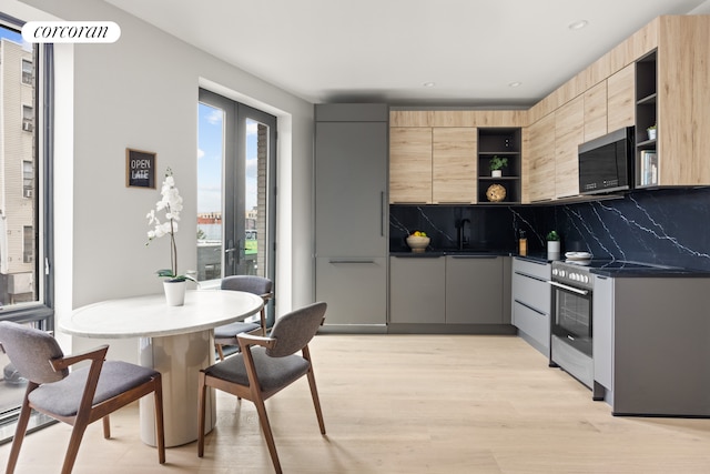 kitchen featuring light hardwood / wood-style flooring, range with electric cooktop, light brown cabinetry, french doors, and decorative backsplash