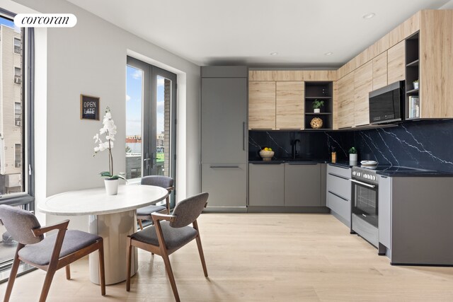 kitchen with open shelves, stainless steel electric stove, light brown cabinetry, modern cabinets, and backsplash