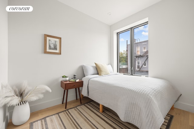 bedroom featuring wood-type flooring and lofted ceiling