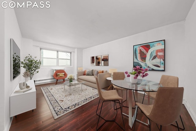 dining area with dark wood-type flooring and a baseboard heating unit