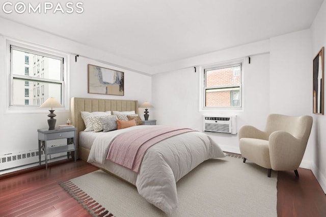 bedroom featuring multiple windows, a baseboard radiator, an AC wall unit, and dark wood-type flooring