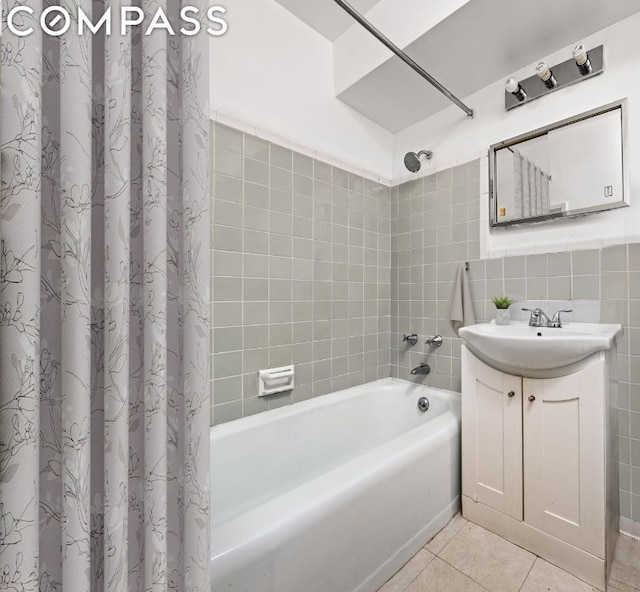 bathroom featuring tile patterned flooring, shower / bath combo, tile walls, and vanity