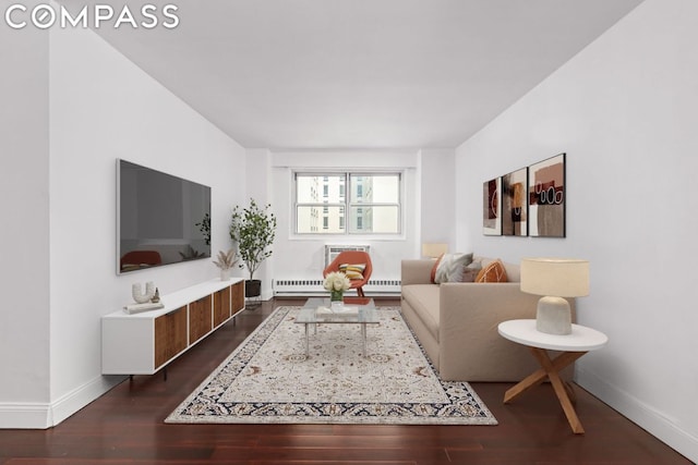 living room with a baseboard heating unit and dark wood-type flooring