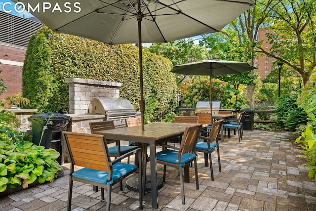 view of patio with an outdoor kitchen and a grill